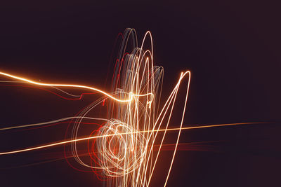 Illuminated ferris wheel against sky at night