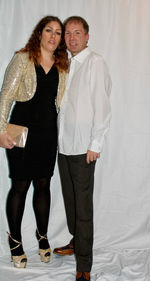 Full length of smiling young woman standing against wall