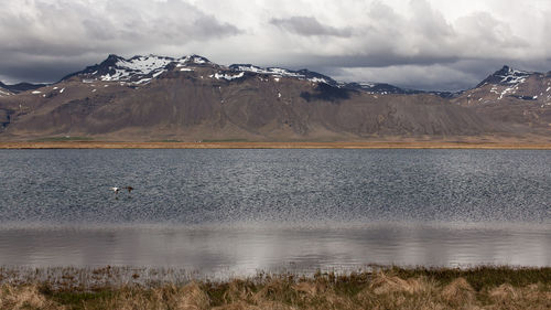 Scenic view of lake and mountains against sky