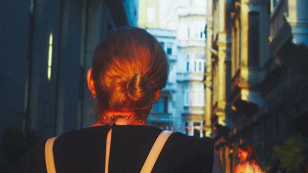 rear view, headshot, real people, one person, adult, architecture, portrait, lifestyles, built structure, hairstyle, women, leisure activity, focus on foreground, short hair, hair, building exterior, outdoors, redhead, standing, human hair