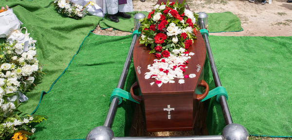 Closeup shot of a funeral casket or coffin in a hearse or chapel or burial at cemetery
