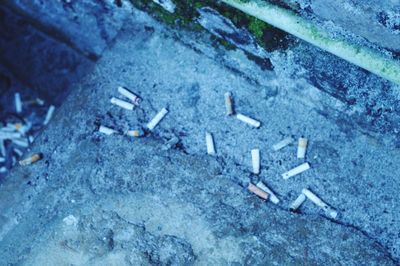 High angle view of cigarette on wall