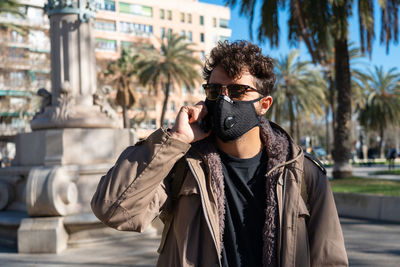 Portrait of young man standing outdoors
