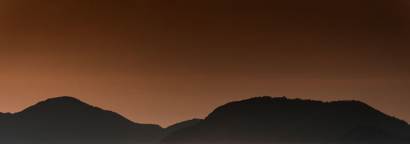 Low angle view of silhouette mountain against sky during sunset