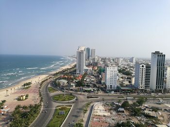 High angle view of road by buildings against clear sky