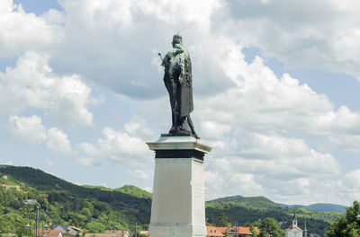 Low angle view of king statue against cloudy sky