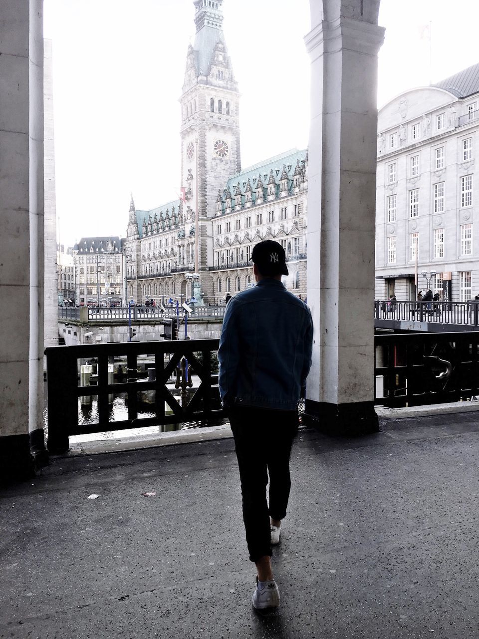 FULL LENGTH REAR VIEW OF MAN STANDING ON BUILDING