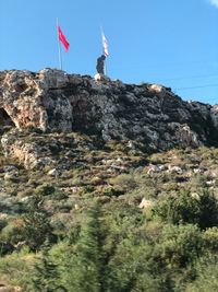 Low angle view of rock formation on mountain against sky