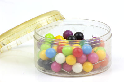 Close-up of multi colored candies in glass jar on table