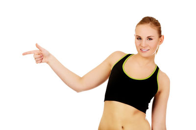 Portrait of smiling young woman against white background