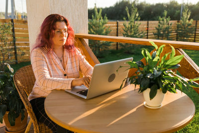 Young woman using laptop at table