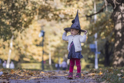 Full length of girl wearing hat standing outdoors