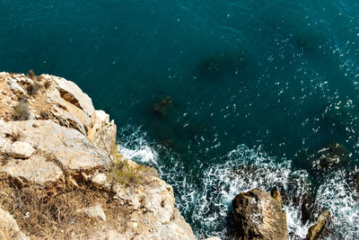 High angle view of rock formation in sea