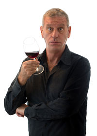 Mid adult man drinking glass on white background