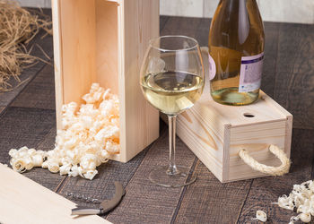 High angle view of white wine with sawdust in box