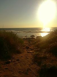 Scenic view of sea against clear sky at sunset