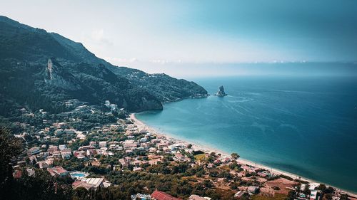 High angle view of sea and cityscape against sky