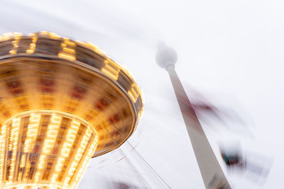 Low angle view of spinning fairground attraction 