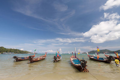 Boats moored on sea against sky