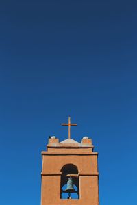 Low angle view of building against clear blue sky