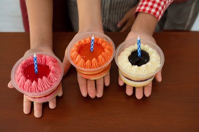 High angle view of woman holding ice cream on table