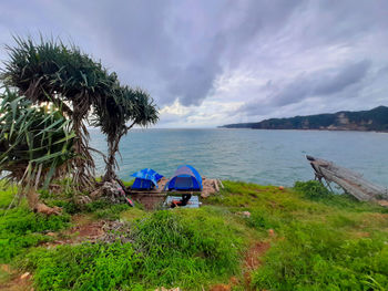 Young local man enjoys his camping trip to a rocky beach in gunung kidul on java, indonesia.