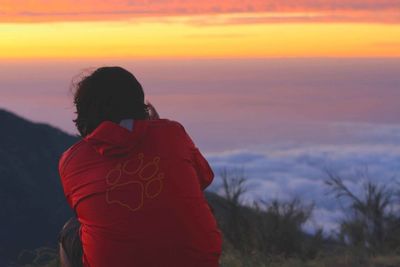 Silhouette of people on landscape at sunset