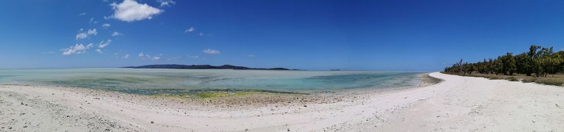 Panoramic view of beach against blue sky