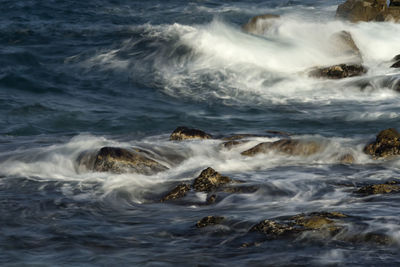 Sea waves splashing on rocks