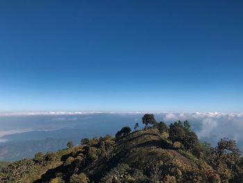 Scenic view of mountains against blue sky