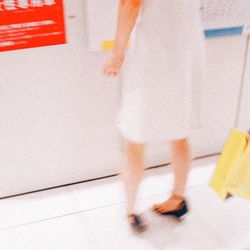 Low section of woman standing on tiled floor