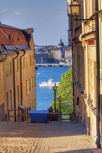 View of city by sea against sky