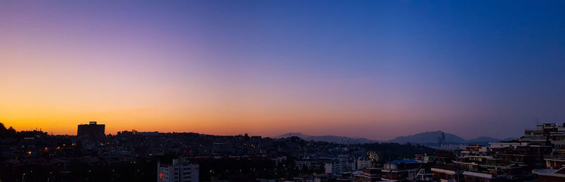 Aerial view of townscape against sky during sunset