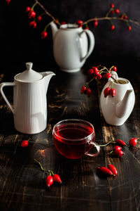 Rosehip tea in white crockery pot