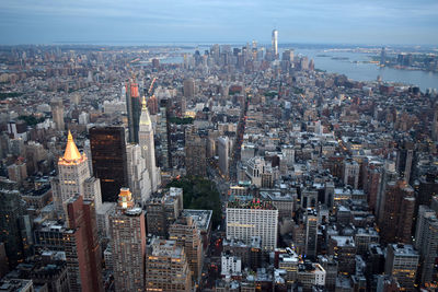 High angle view of cityscape against cloudy sky during sunset