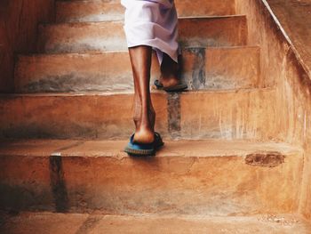 Man feet climbing the stairs to the top of sigirya rock in sri lanka