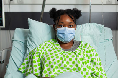Portrait of young woman wearing mask in hospital