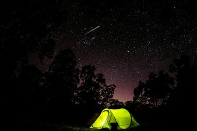 Low angle view of tent against star field
