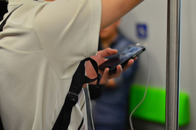 Close-up of man using mobile phone