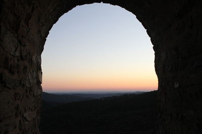 View of landscape against clear sky during sunset