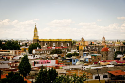 High angle view of buildings in town against sky