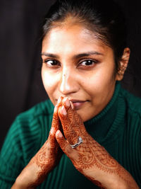 Portrait of young woman holding camera