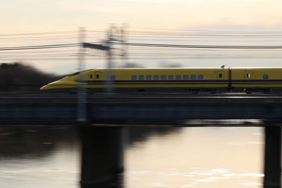 High speed train on bridge against sky