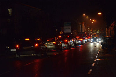 Cars on city street at night