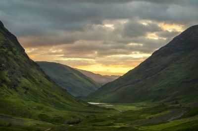 Scenic view of mountains against cloudy sky