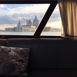 Punta della dogana and canal seen through window in boat