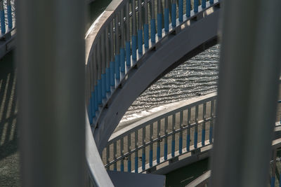 High angle view of curvy bridge by sea on sunny day