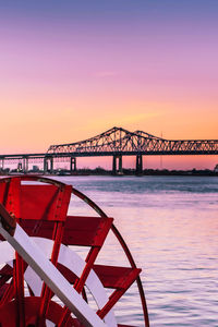 New orleans bridge over the mississippi river during sunset