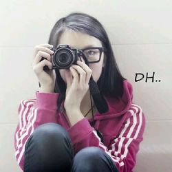 Portrait of woman photographing