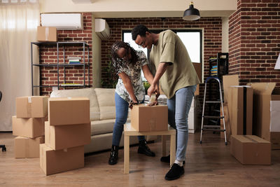 Man and woman packing box at home